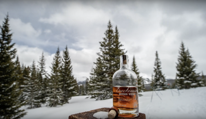 Breckenridge Distillery bottle of whiskey perched near ski slope