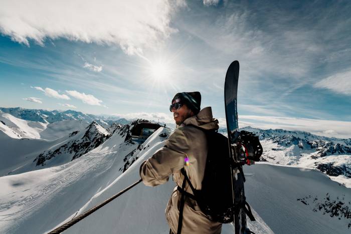 Skier carrying skis in Glacier Express film