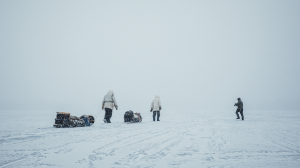 two Native American people trekking through snow in snow camping film