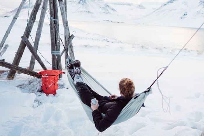Female model lounging in The Campo hammock in winter