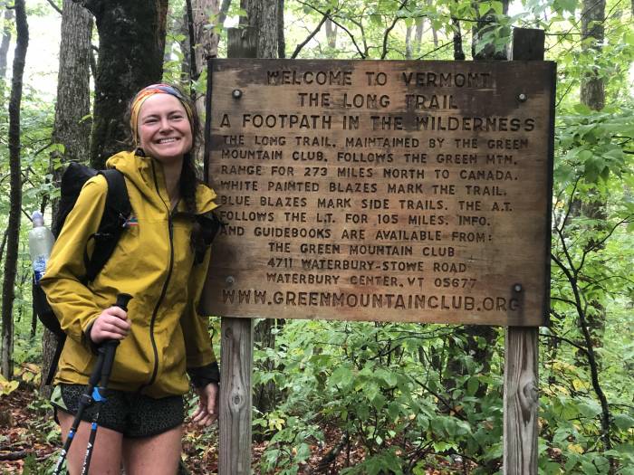 Nika Meyers poses with sign at finish of Long Trail