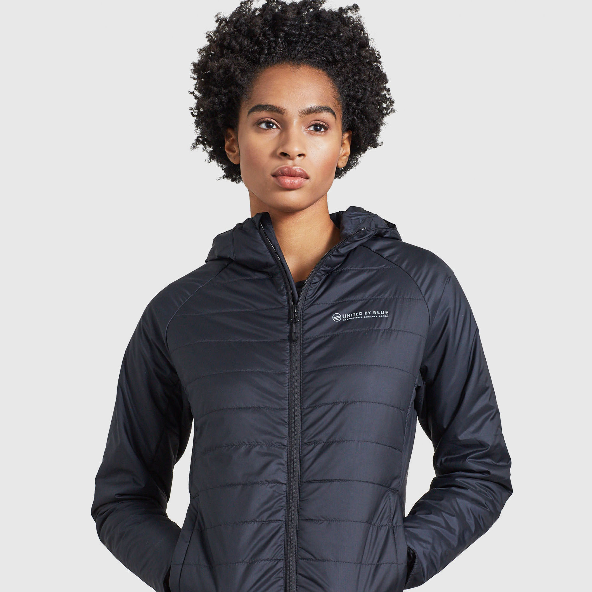 United By Blue Bison Ultralight Jacket on Black model with short curly hair