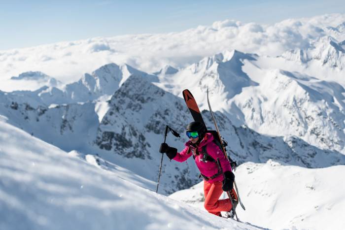 Skier climbing up snowpack wearing Jack Wolfskin outerwear