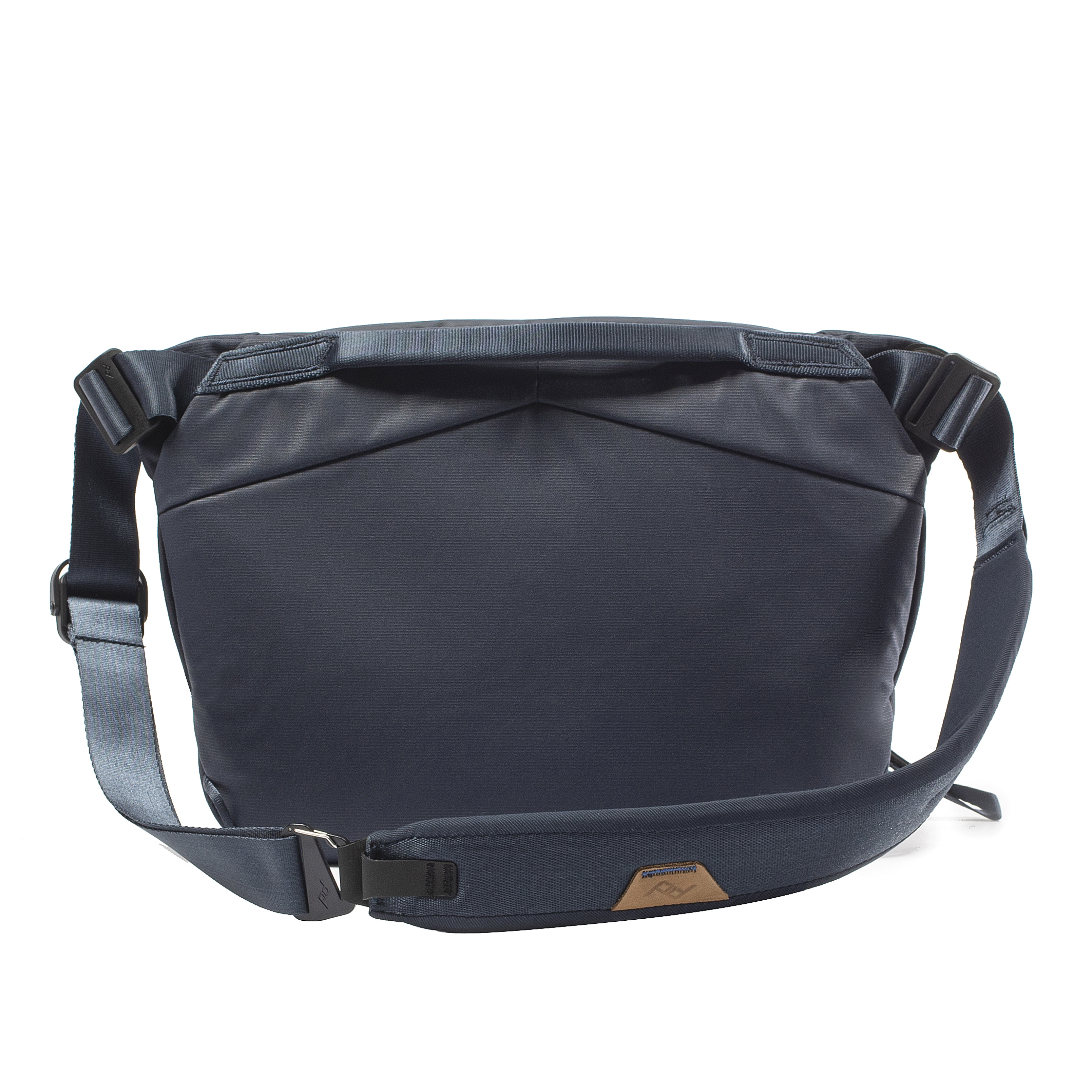 View of back panel and strap of Peak Design Everyday Sling Bag against white background
