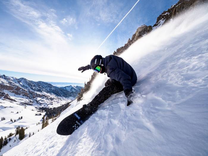 Snowboarder makes a turn.