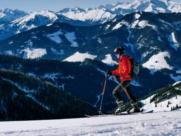 skier in red jacket and black helmet wearing Impetro Backpacks Ski Pack