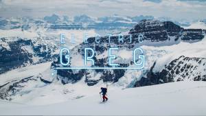 "Electric Greg" in neon lightbulb font over a picture of Greg hill skinning across wide snowy mountain