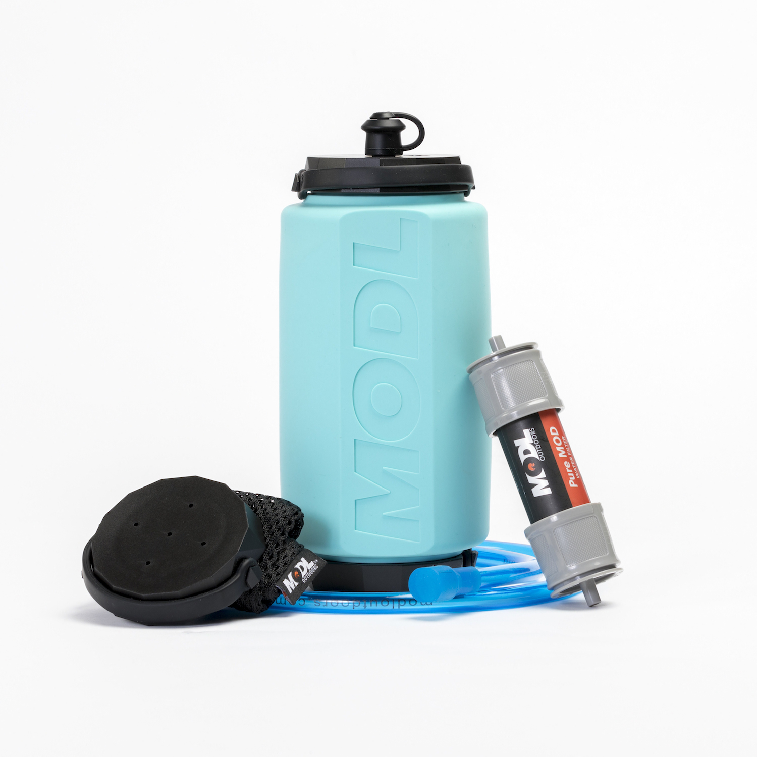 MODL bottle next to mesh carry bag, shower, and water filter attachments against white background