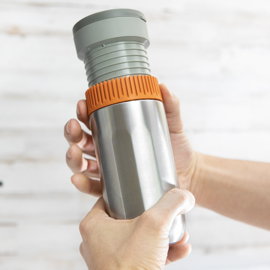 hands holding a Wacaco Pipamoka coffee maker press