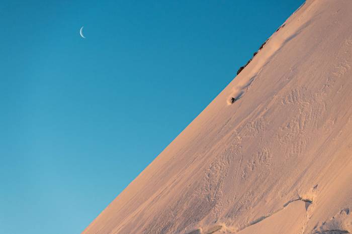 Faction skier on steep line in Swiss Alps