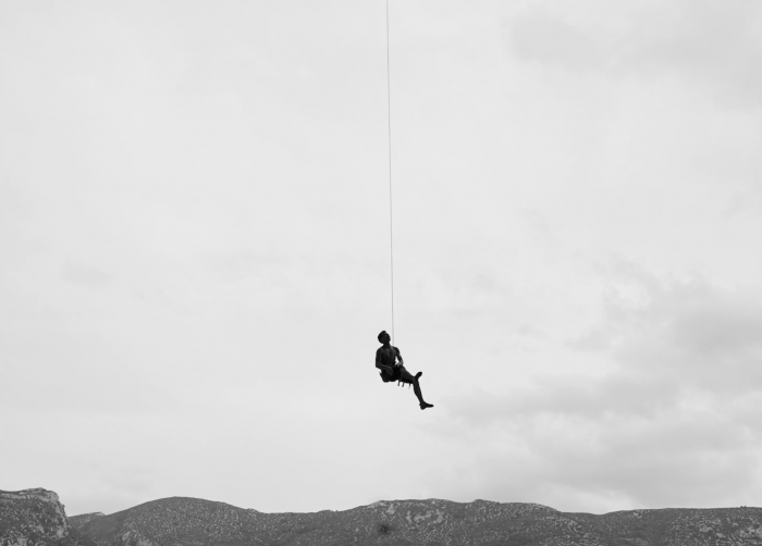 a climber hanging from a rope in Spain