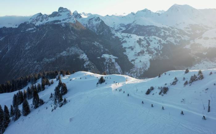 wide angle view of a line of fat bike cyclists riding in the UCI Snow Bike Festival