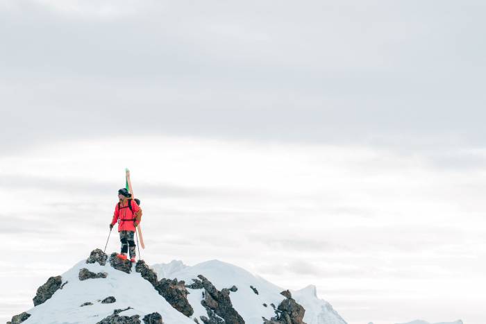 Skier at the top of a peak using Limited Edition Faction touring skis