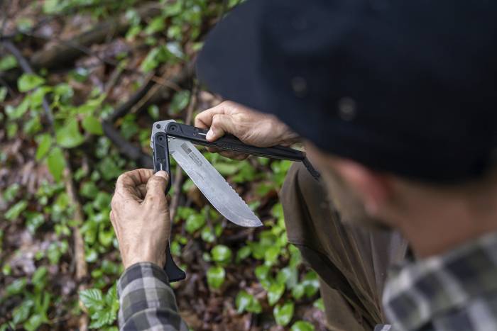over the shoulder view of man using the gerber double down machete