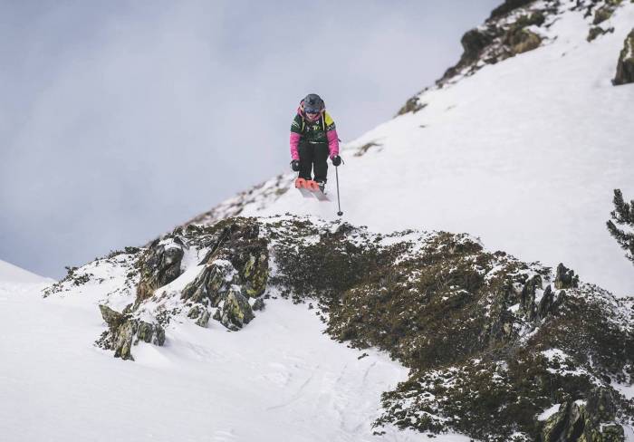 Jacqueline pollard skier flying off jump of rocky outcropping