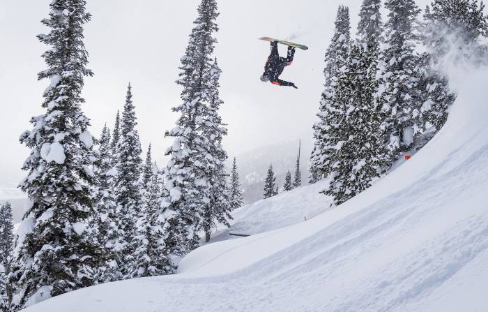 snowboarder upside-down doing front flip at Natural Selection Tour