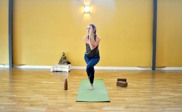 The author demonstrating stretch and balance in eagle pose.