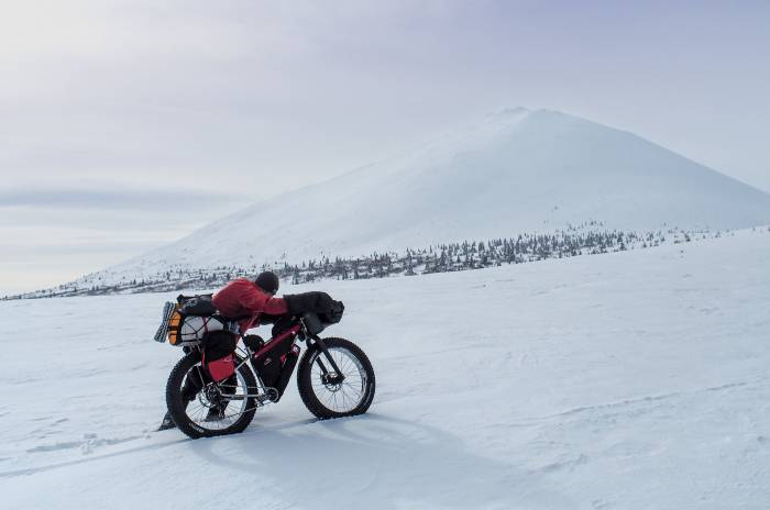 A final trail invitational finisher approaches the finish line in Nome.