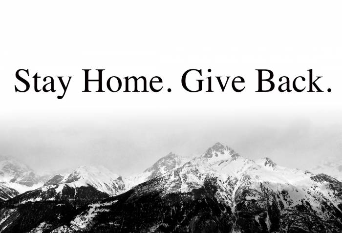 "stay home, give back" text above black and white mountain range