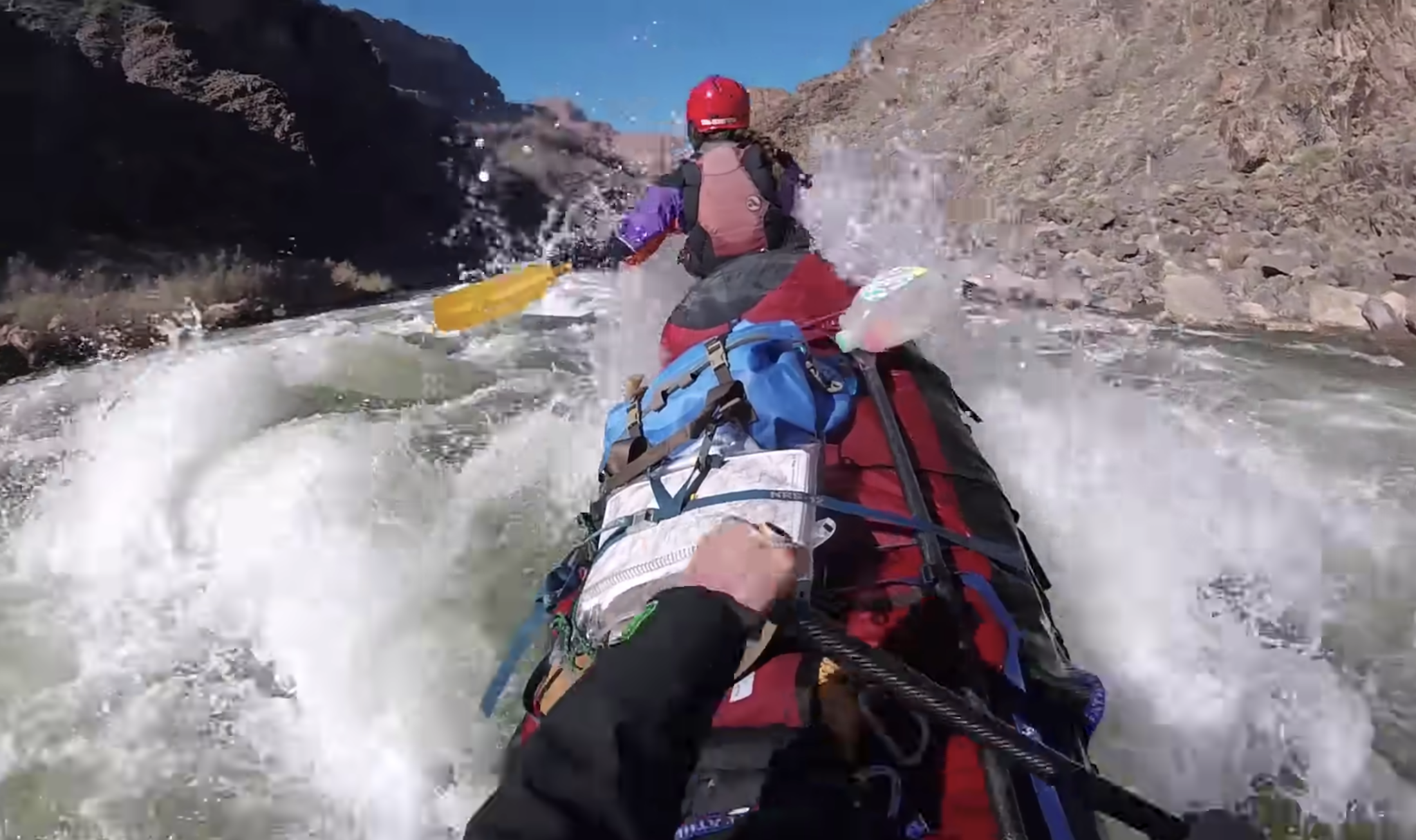 canoeists battling rapid in tandem canoe in the Grand Canyon