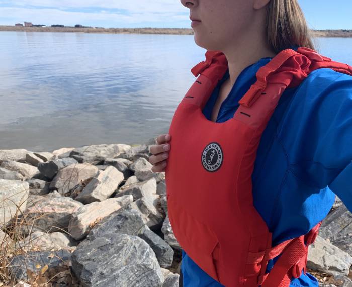author wearing a blue shirt and the Mustang Survival Khimera PFD