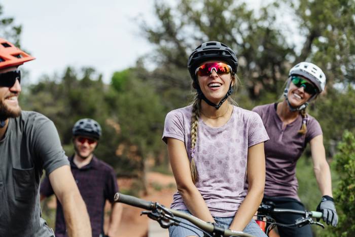 People mountain biking in Club Ride gear