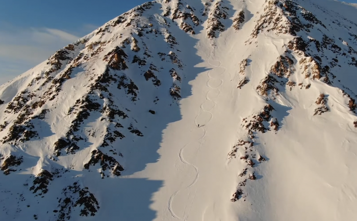 far angle view of one skier descending mountain