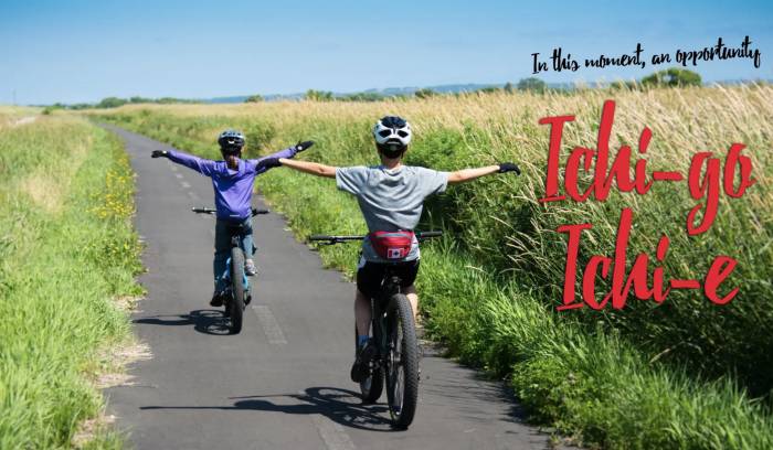 kids biking on pavement trail with arms out (no handlebars!)