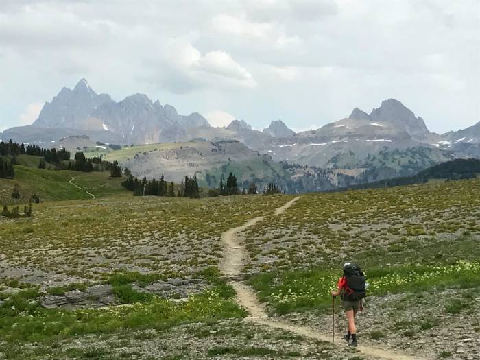 hiker on an open singletrack trail in Grand Tetons national park