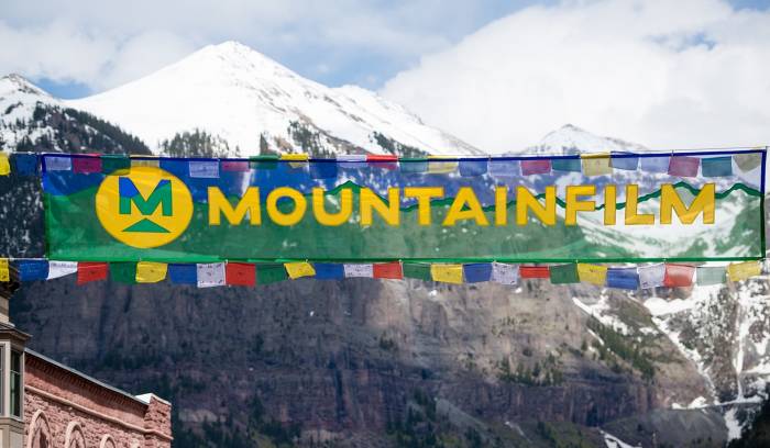 mountainfilm festival banner with prayer flags in wind