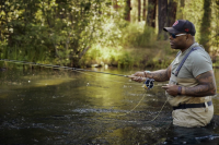 chad brown fly fishing in waist-high water