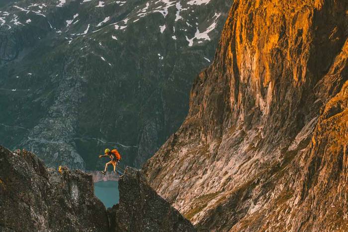 Rock Climber Jumping Across Cliffs in Arc'teryx Gear