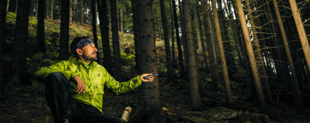 Ultimate Gift Guide: Win the Holidays With Outdoor Gear Person in the woods using Ledlenser P7R Signature Edition Flashlight
