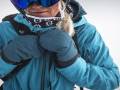 The Best Winter Mittens of 2022-2023 Person Wearing Black Diamond blue softshell jacket and blue insulated mittens and goggles