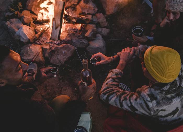 People Sitting Around Campfire Wearing Stoic Apparel