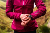 runner wearing magenta inov-8 jacket and COROS watch