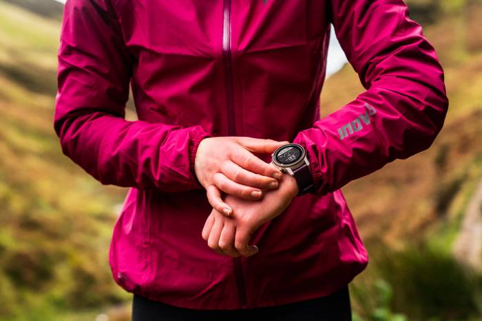 runner wearing magenta inov-8 jacket and COROS watch
