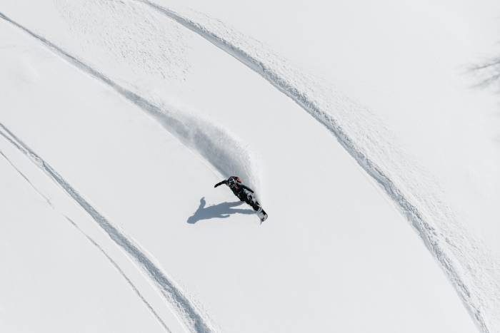 Backcountry Snowboarder Riding in Powder