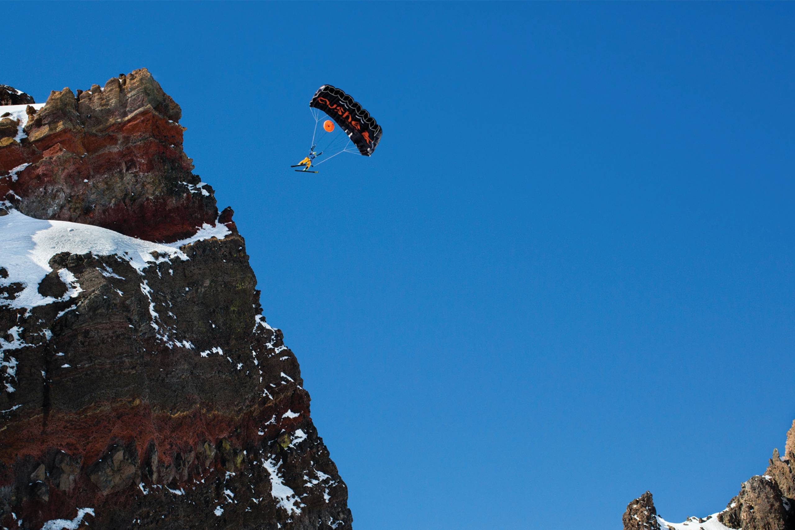 matthias BASE jumping off rocky cliff