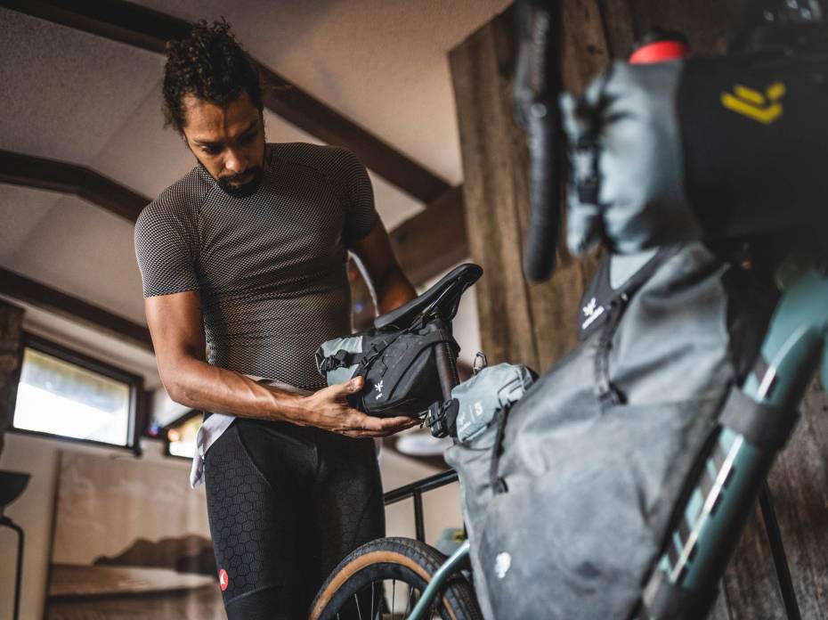'Chosen Confluence': Bikepacking and Climbing Through Florissant, Colorado Black biker attaching seat bag to bike