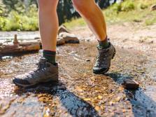 The Best Hiking Boots of 2022 hiker wearing hiking boots through stream