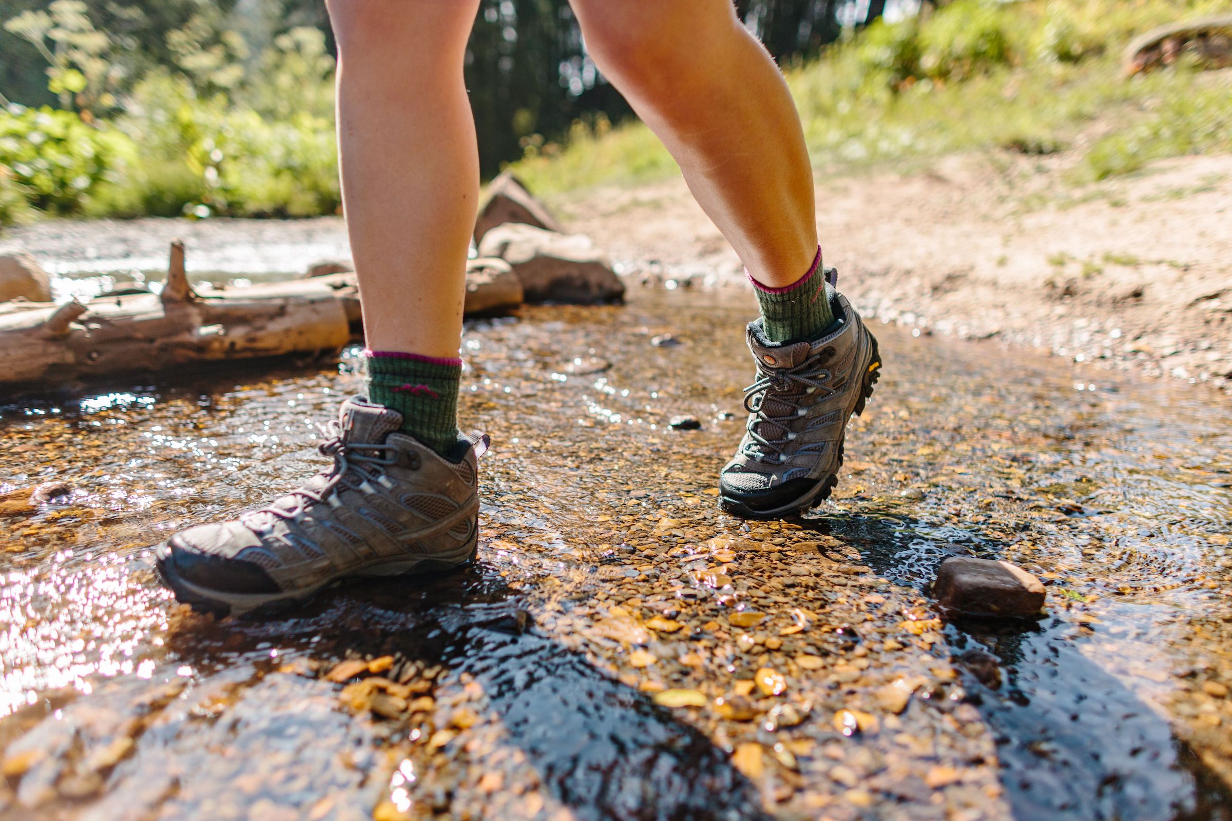 hiker wearing hiking boots through stream