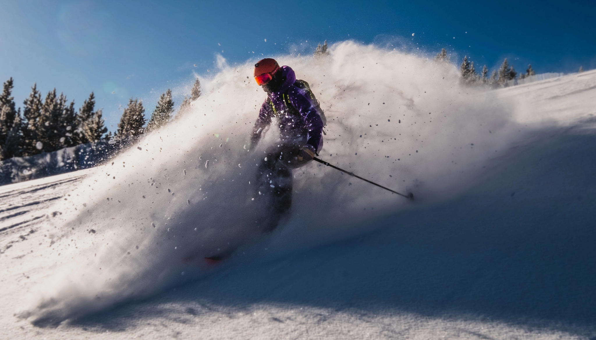 Lahota skier connor ryan skiing downhill through powder at Eldora Mountain