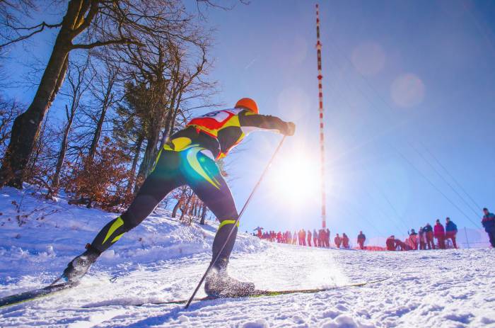 nordic skier traveling uphill training for Olympics
