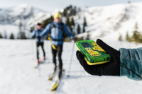 'Safety Check' on PIEPS and Black Diamond Avi Beacons — Again skier holding up pieps dsp pro transceiver with two other skiers in background