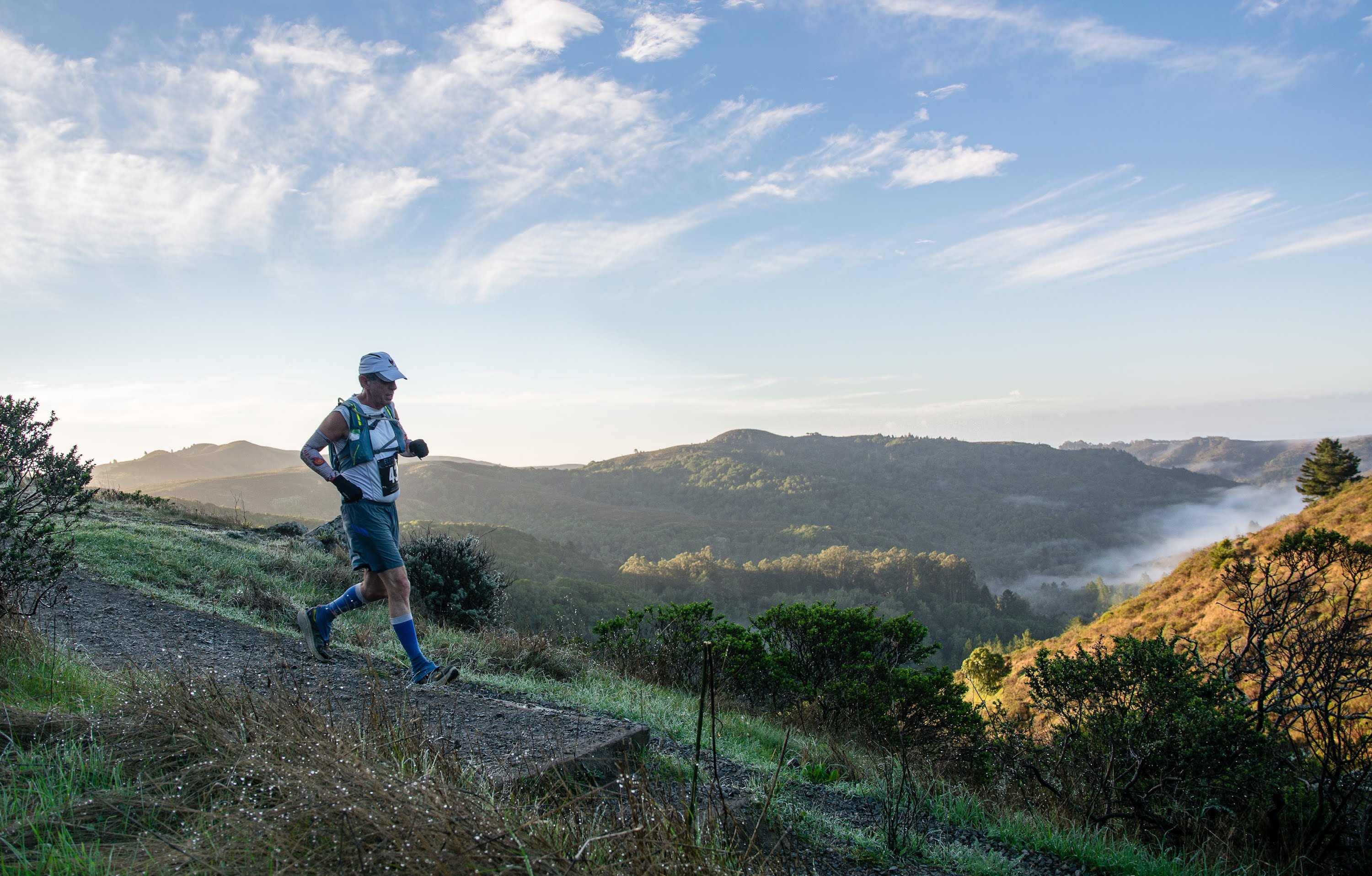 eric spector running in 2018 eric spector running down wide gravel trail with mountain overlook