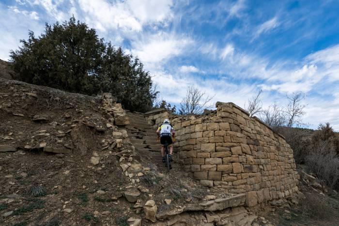 Cyclist riding up stair ruins in Trinidad, CO