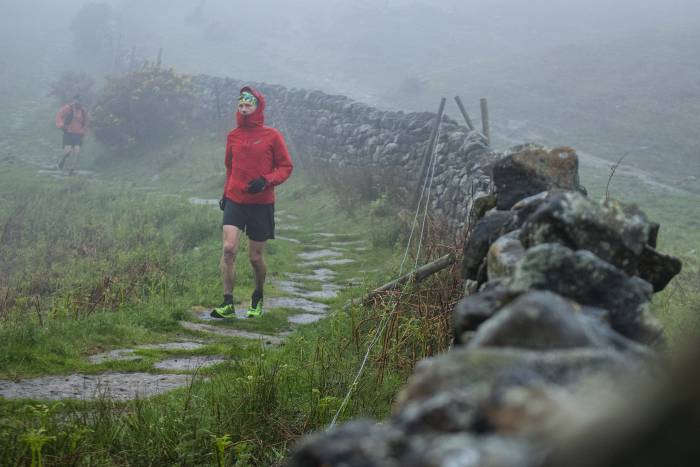 Damian Hall running on an English footpath in the rain