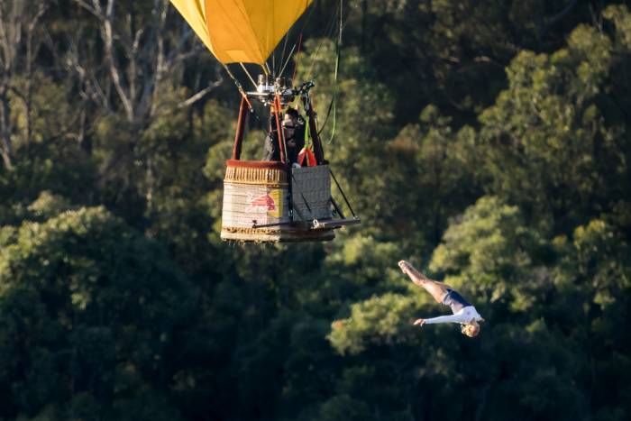Cliff diver Rhiannan Iffland performs a high dive from a hot air balloon in Australia