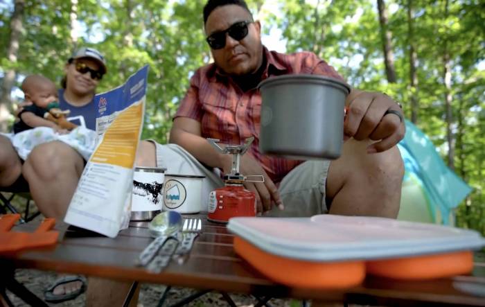 tony galbreath with wife and child in camp chairs outdoors